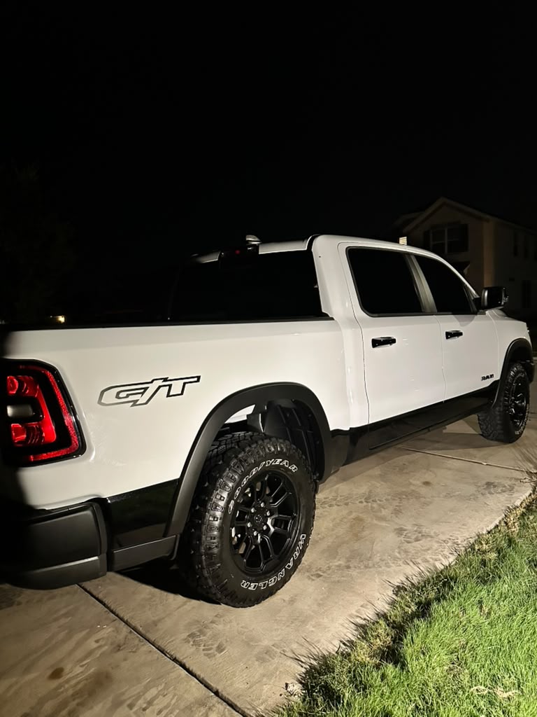 White pickup truck photographed in a driveway at night