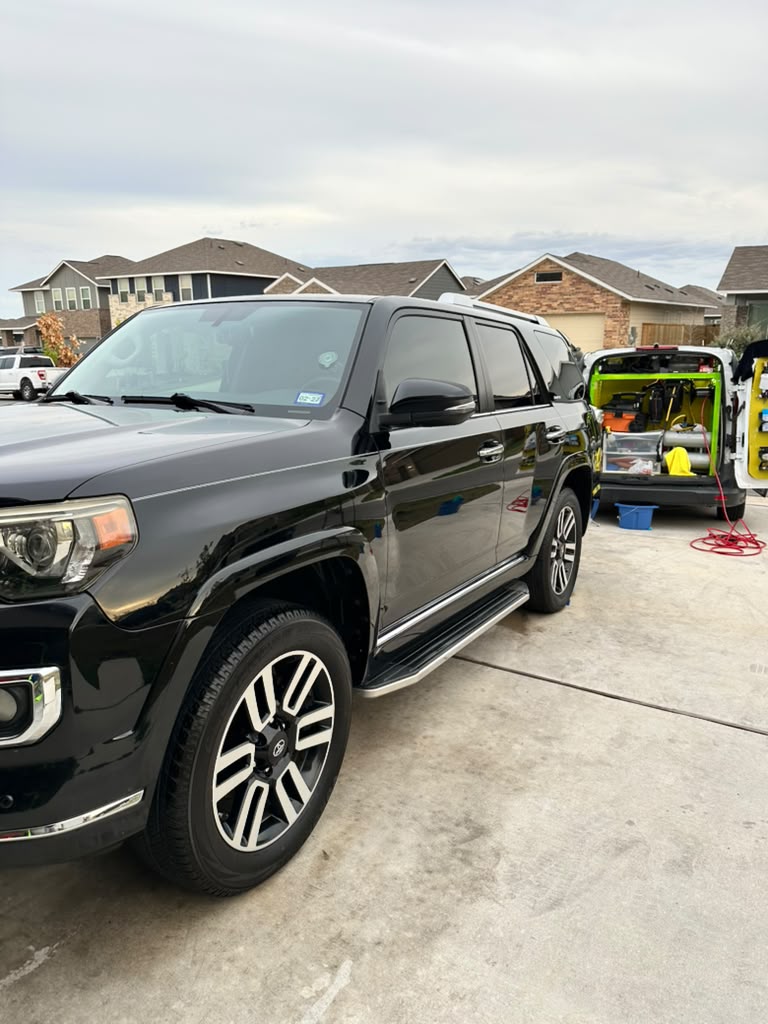 Black SUV beside the mobile detailing van