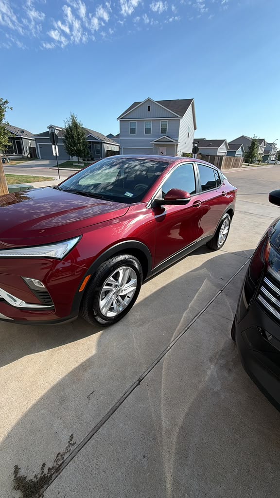 Red SUV with a glossy finish in a sunny driveway